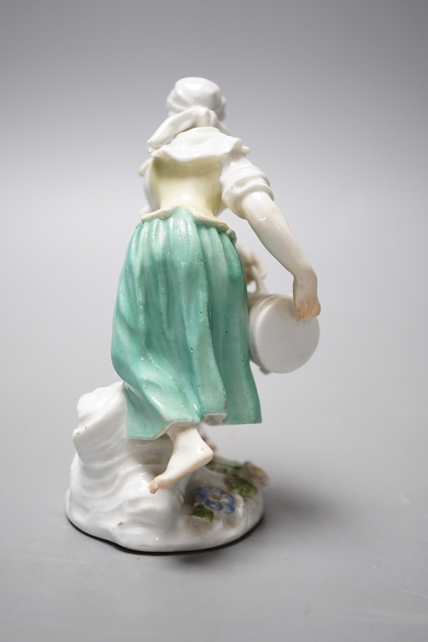 An 18th century Meissen figure of a girl pouring water from a jug on flowers at her feet, c.1755, 12cm tall